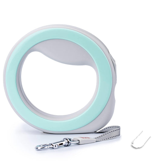 Teal and white retractable dog leash with circular handle and detachable cord on a light gray background.